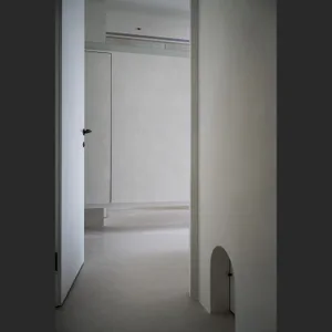A minimalist concrete interior space with simple design elements and white walls.