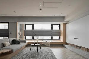A modern living room with a concrete floor, minimalist design, and large windows.