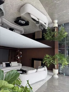 Modern living room with minimalist furniture and green plants.