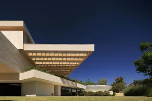 An abstract architectural design featuring a modern exterior made of concrete and glass.