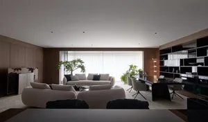 Modern living room featuring white leather furniture, minimalist decor, and floor-to-ceiling windows with natural light.