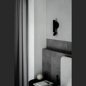 Modern minimalist bedroom featuring concrete walls