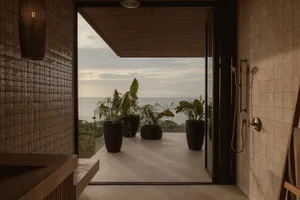 A minimalist balcony featuring concrete and glass elements.
