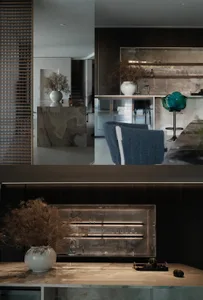 Modern kitchen featuring marble countertops and concrete elements, including a sleek bar counter and stylish seating.