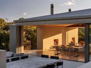 A modern residential interior featuring concrete and glass materials.