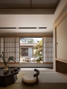 Modern minimalist living room with wooden furniture and floor-to-ceiling windows.