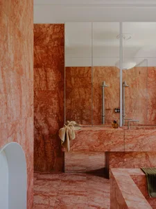 Modern bathroom interior with marble walls and flooring, featuring a sleek, minimalist design.