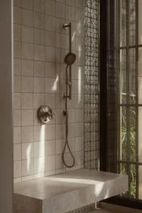 A modern bathroom with a tile shower featuring a handheld showerhead, overhead shower, and floating vanity.
