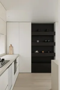 Modern kitchen featuring white walls and wooden shelves with dishes displayed.
