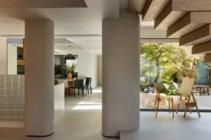 An open, modern living space with concrete features including walls, floor, and ceiling.