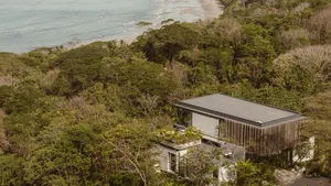 A modern residential home with wooden accents and concrete walls.