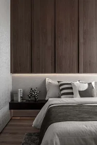 A modern bedroom with a wooden headboard, metal and leather accents, and a striped blanket.