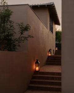 Outdoor staircase with lanterns on tiled steps next to a modern home