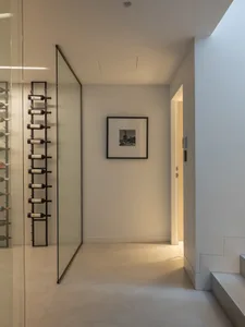 A minimalist storage room with glass walls and a metal ladder.