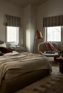 A minimalist bedroom featuring soft furnishings and fabric elements.