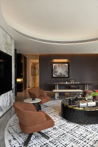 A minimalist living room featuring marble accents and leather furniture.