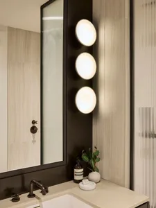 Modern bathroom featuring sleek glass and porcelain materials.