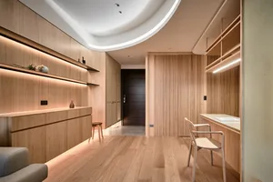 Modern minimalist apartment interior featuring a wooden floor and furniture.