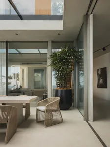 Modern residential interior with concrete and glass elements.