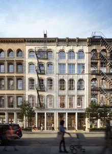 Street view of a retail storefront with brick exterior and large glass windows.