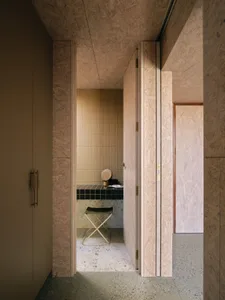 Minimalist bathroom with ceramic tiles on walls and cork flooring.