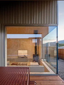 A modern living room extension featuring glass and steel materials.