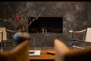 A modern living room with marble walls and seating