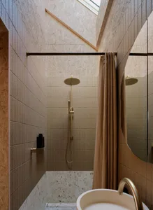 A modern minimalist bathroom with concrete elements and a large window.