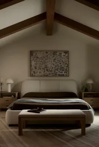 A modern minimalist bedroom with plush fabric bedding and wooden furniture.