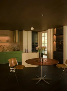 A modern residential kitchen featuring a marble countertop and floor-to-ceiling cabinets.