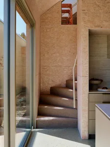 Stairs with wooden treads and railings in an industrial design setting.