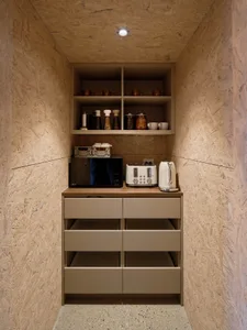 A modern kitchen with wooden cabinets, cupboards, and drawers.