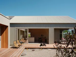 Modern residential exterior with metal-clad panels, featuring a sleek, minimalist design.
