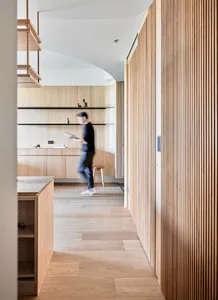 A modern kitchen featuring wooden cabinets and a minimalist design.