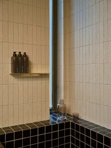 Minimalist bathroom featuring black granite tiles and a modern design aesthetic.