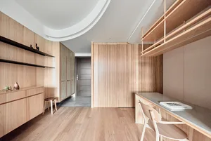 Modern minimalist office space featuring wood finishes and open shelving.
