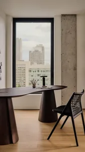 Modern workspace featuring a wooden desk with a city view.
