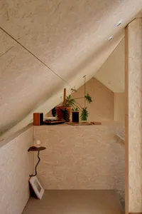 Modern minimalist bedroom featuring OSB panels as wall covering