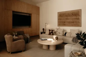 A modern, minimalist living room featuring plush, comfortable seating, a sleek coffee table, and a large abstract artwork on 