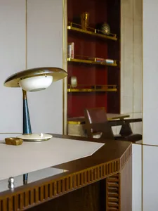 A modern desk with wood, leather, and metal materials.