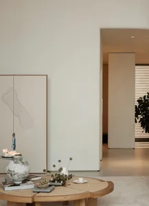 A minimalist living room featuring modern furniture, a concrete ceiling, and a large window with natural light.