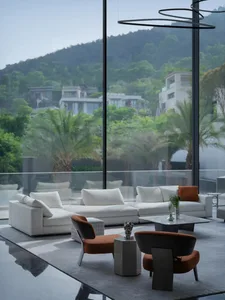 Modern minimalist living room with white walls and black accents.
