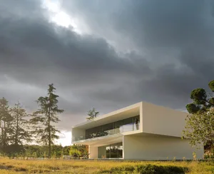 A modern house with a glass and concrete exterior.