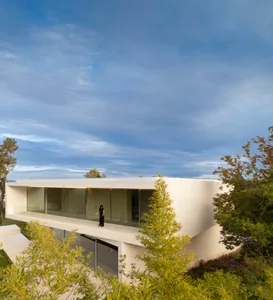 Modern house with large glass windows and white exterior walls