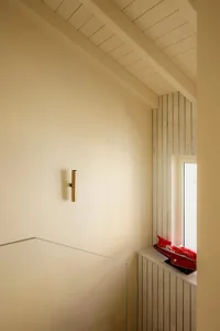 Modern bathroom with minimalist design featuring a marble wall and floor.