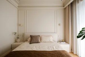 A minimalist bedroom with a textured cotton bedspread and beige walls.