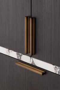 Modern furniture featuring marble, brass, and dark wood finishes.