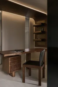 Modern industrial home office featuring a wooden desk with a black leather chair, designed for efficiency and comfort.
