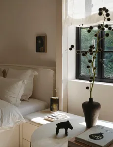 Minimalist bedroom featuring a raised floor and white design elements.