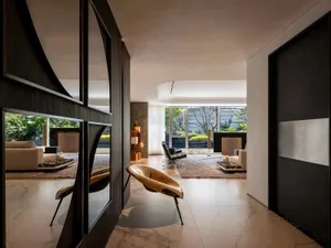 Modern living room with concrete and marble materials, featuring minimalist design.